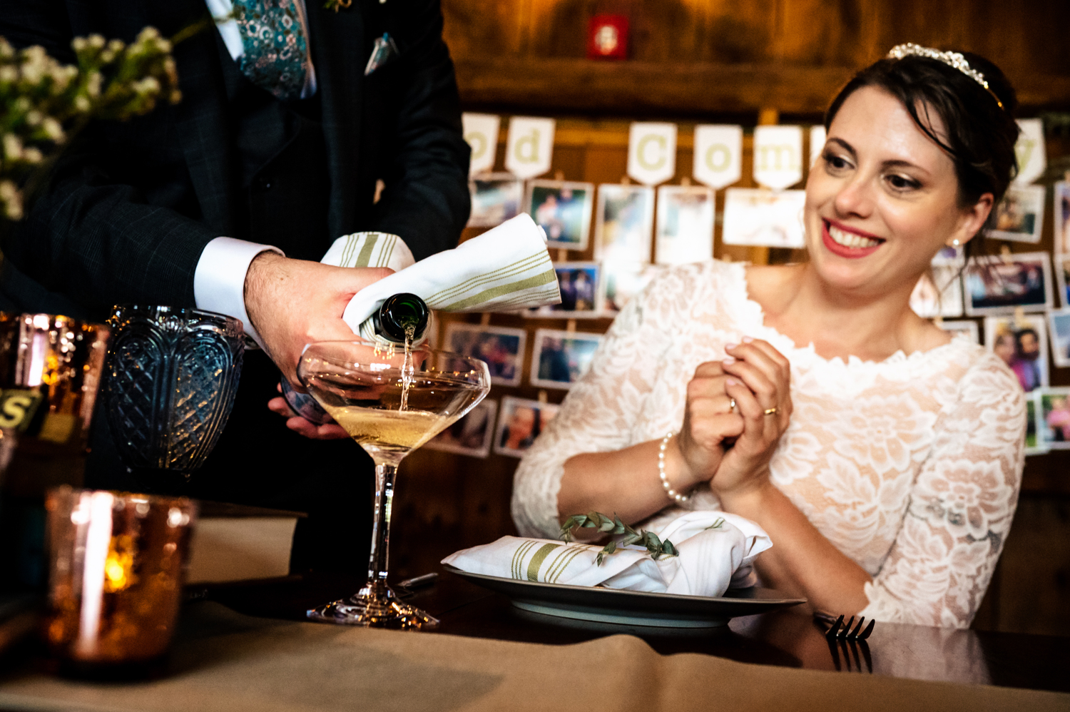 A caterer pouring a glass of champagne for Anne on her wedding day