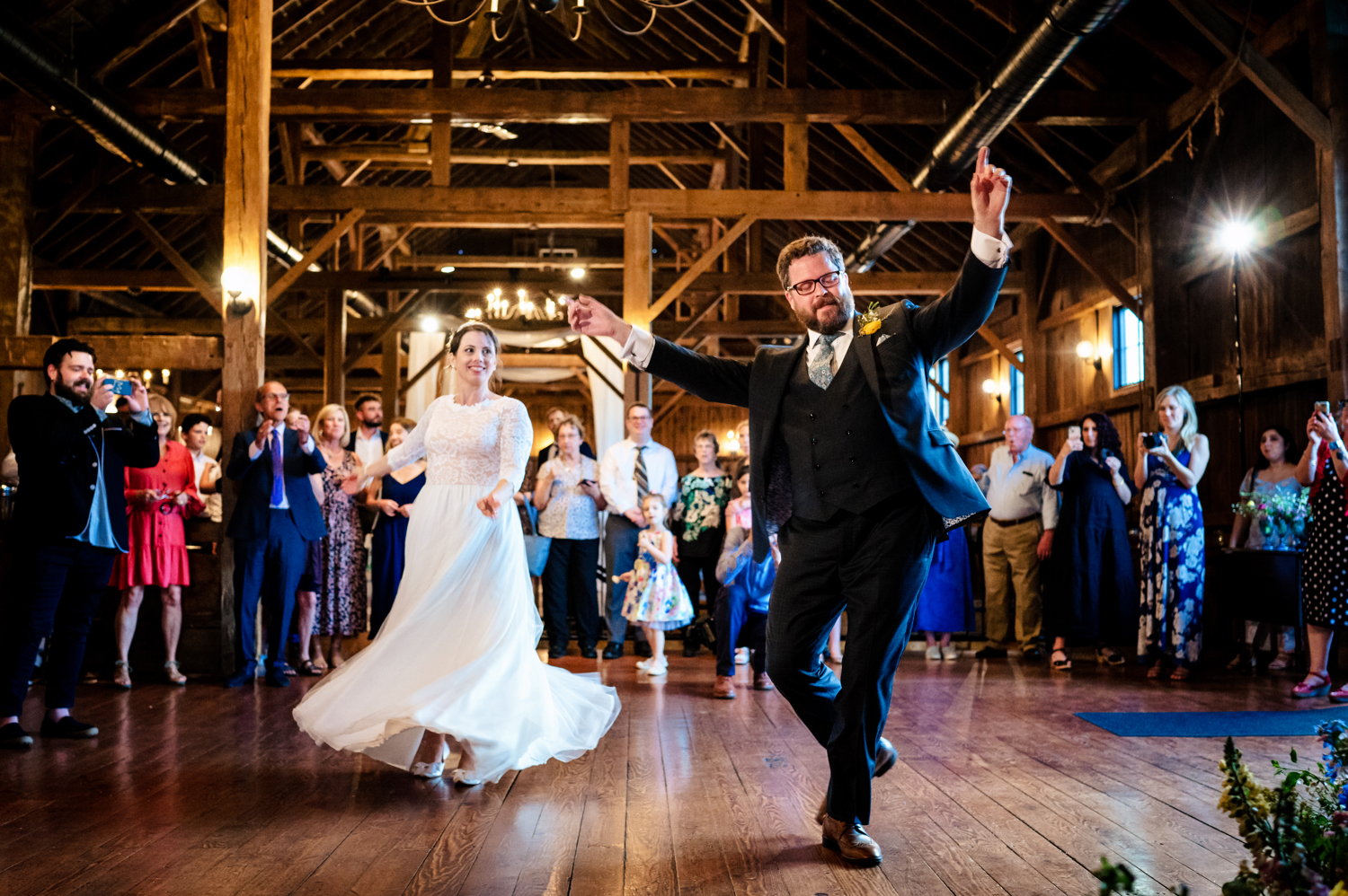 Anne and Jed dancing together in the barn space at their Vermont wedding