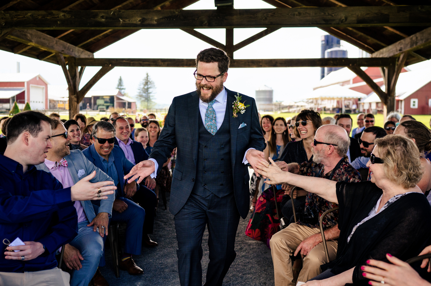 Jed receiving high fives as he walks down the aisle at his Vermont wedding