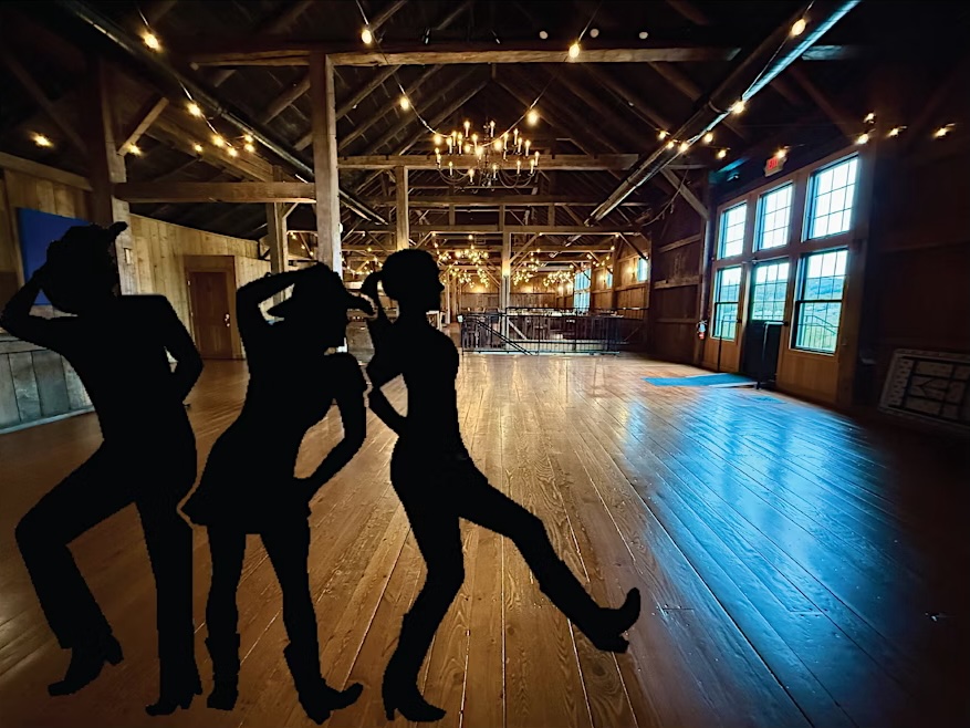 Silhouettes of people line dancing in the Boyden Barn